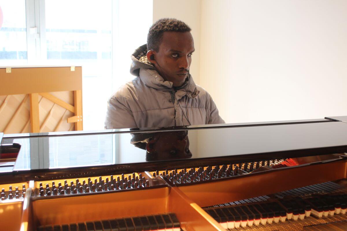 Visually impaired project participant Habtamu Shiawul from Ethiopia plays a piano.